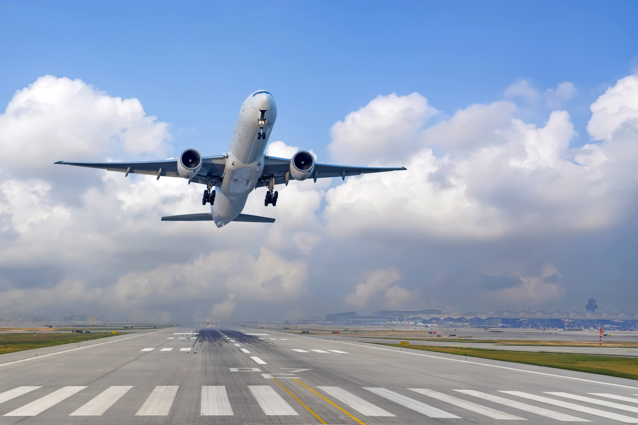 Airplane lifting off the runway into open sky