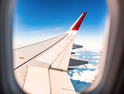 View of an airplane wing above the clouds at cruising altitude